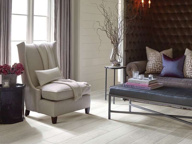 grey armchair on laminate flooring